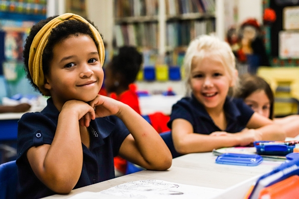 Two lower school girl students in class.