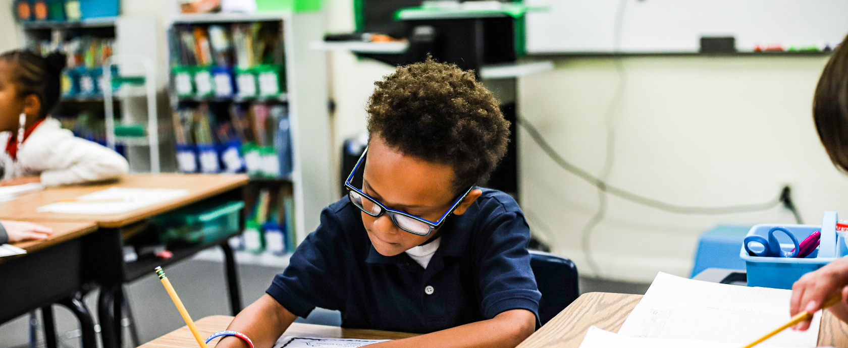 Elementary student in class taking notes. Discovering TRUTH in Academics.